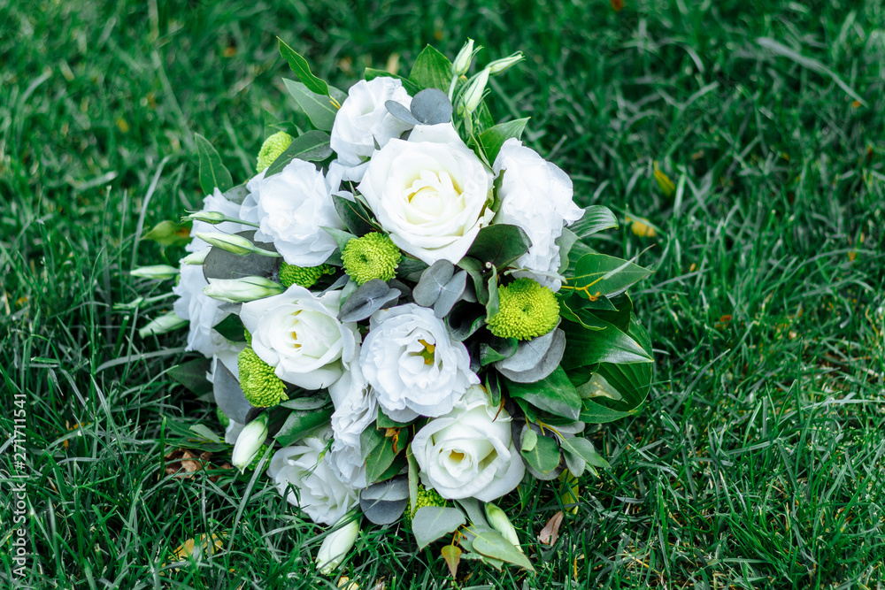 Wedding bouquet made of white roses on a natural background Wedding bouquet made of white roses on a natural background