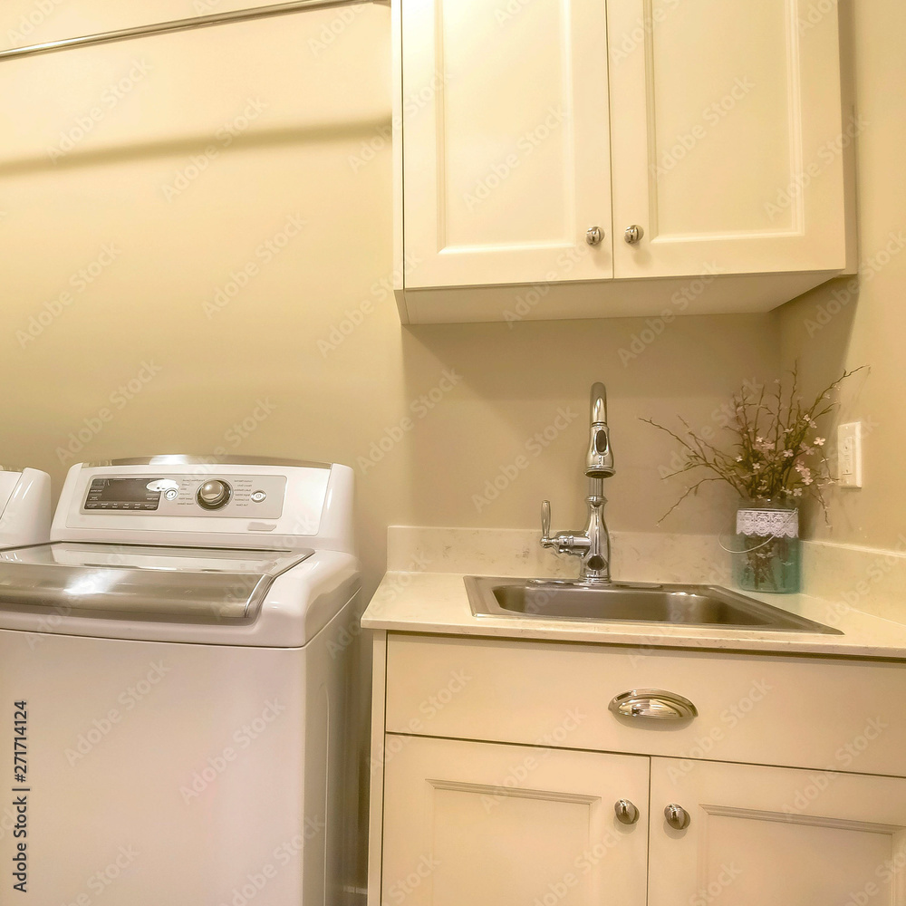 Frame Square Washing machine and dryer inside the laundry room of a house Frame Square Washing machine and dryer inside the laundry room of a house