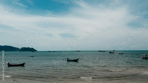 Tropical beach with local boat at island in Thailand. Sea beach view background © Arnang