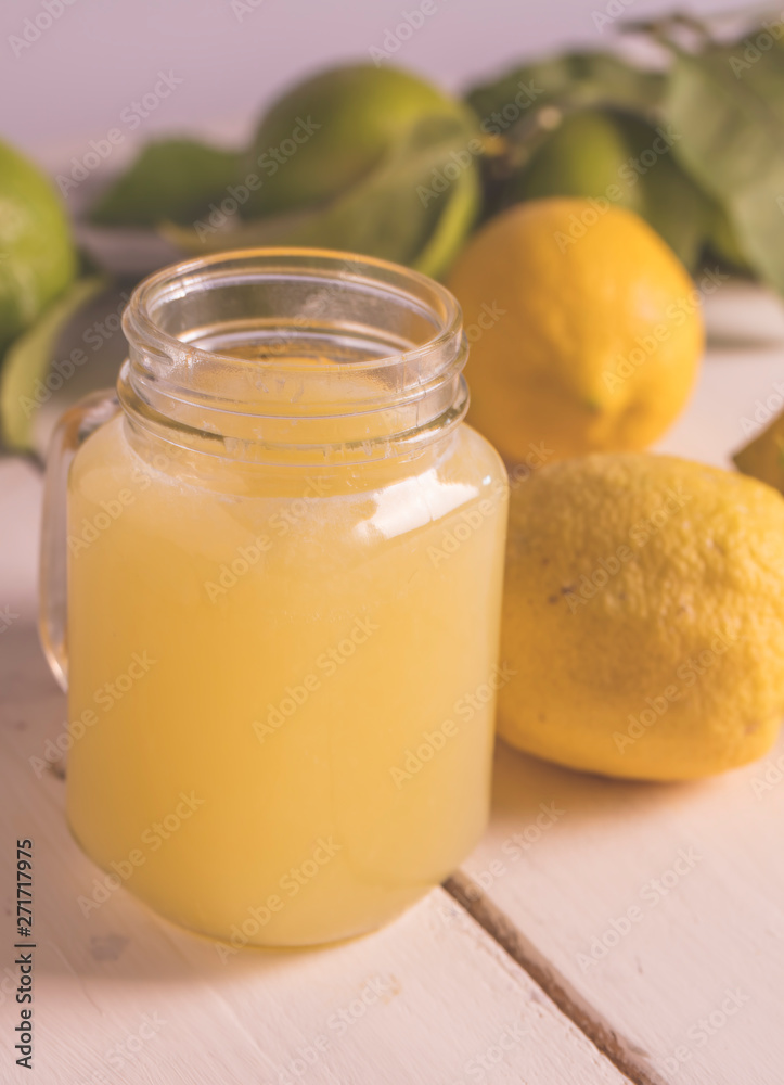 Delicious jar of Lemon juice lemonade on a wooden table. Delicious jar of Lemon juice lemonade on a wooden table.