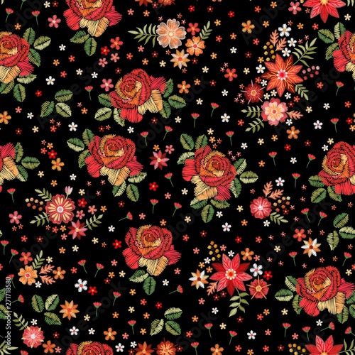 Embroidery seamless pattern with roses and wild flowers on black background. Trendy design for fabric and textile. Fancywork print.