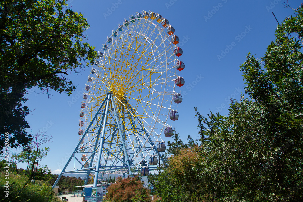 attraction wheel review.Attraction wheel review over park at summer day. Attraction in Tbilisi, Georgi.