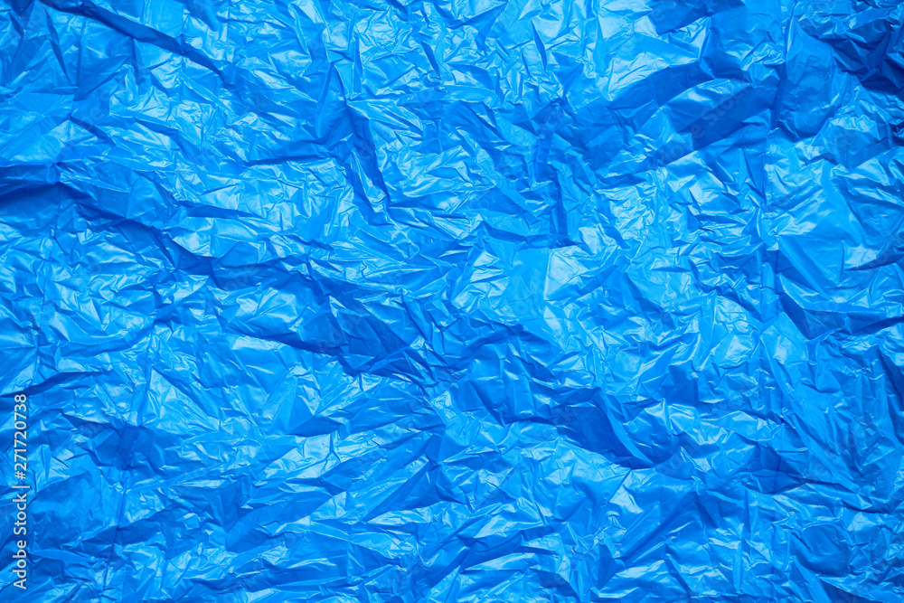 Blue crumpled plastic bag texture background. Waste recycle concept. Polyethylene clear garbage bags. Blue crumpled plastic bag texture background. Waste recycle concept. Polyethylene clear garbage bags.