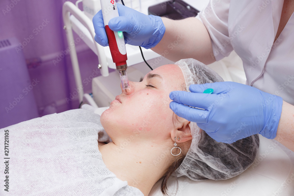 The girl at the reception at the beautician. The process of mesotarpia with the introduction of serum under the skin. The girl at the reception at the beautician. The process of mesotarpia with the introduction of serum under the skin.