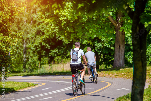 Wallpaper Mural Cyclists ride on the bike path in the city Park  Torontodigital.ca