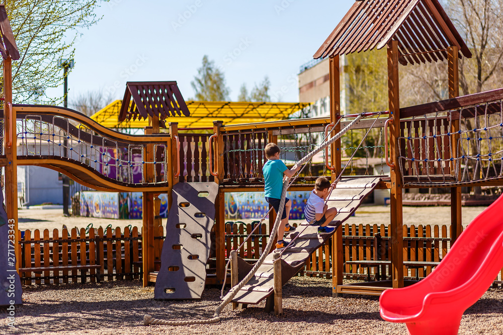 Fototapeta premium preschool children play on the wooden Playground