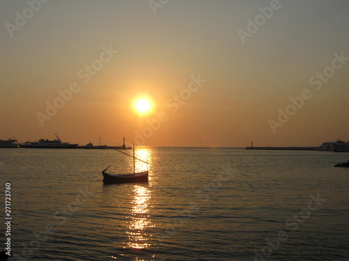 small boat on the sunset
