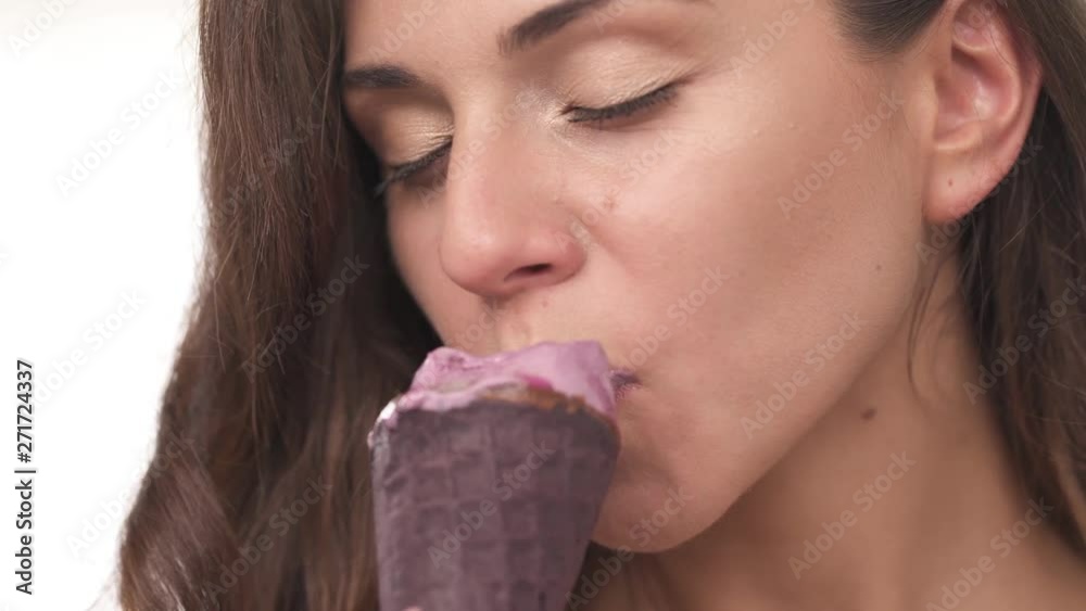 Sexy young woman tasting ice cream in seductive manner. Isolated, on blurred background, close-up demonstration video Sexy young woman tasting ice cream in seductive manner. Isolated, on blurred background, close-up demonstration video