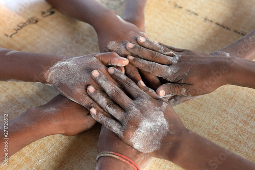 Close-up of hands of a group of boys playing carrom in Dhaka, Bangladesh
