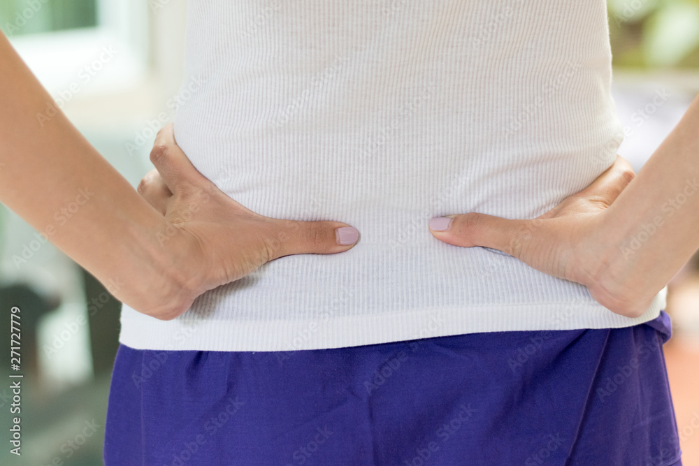Back pain in woman concept. Female patient hurt from lower backache