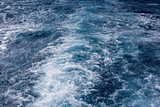 Cruise ship wake Wave ocean trace on blue sea water background.