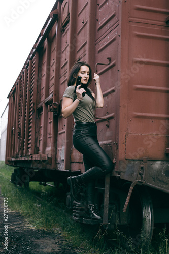 Powerful Woman Holding Gun Action Movie Style. Train adventure. Military girl with .