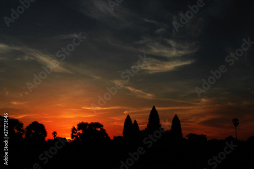 blurred background picture of shilouette view of sunrise in Angkor Wat temple in siem reap of Cambodia © k