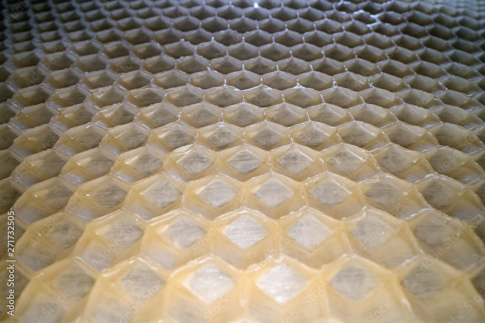 Fototapeta premium Wide angle macro shot of honeycomb wax. Abstract view of honey comb hexagon shape pattern