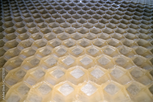 Wide angle macro shot of honeycomb wax. Abstract view of honey comb hexagon shape pattern