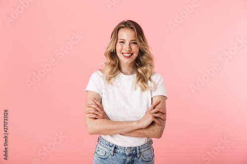 Fotografija Beautiful young blonde woman posing isolated over pink wall background
