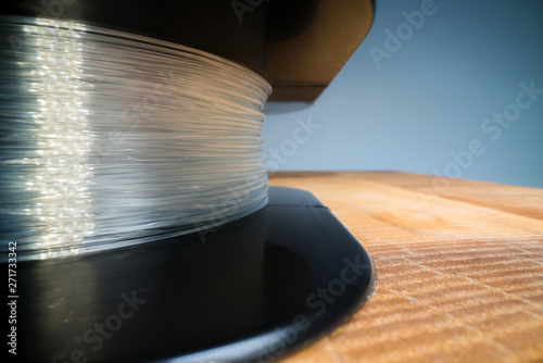 Macro shot of fishing line spool texture. Monofilament line wrapped on a black spool. Fishing gear