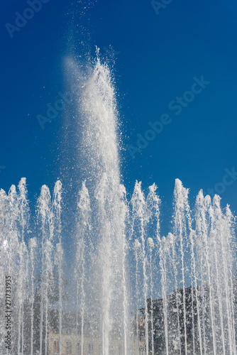 Fountain splashes on a clear blue sky. Piazza Castello  Milan  Lombardy  Italy