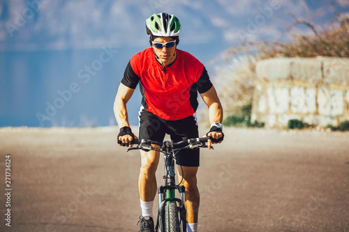 Fototapeta Naklejka Na Ścianę i Meble -  Man ride mountain bike on the road. Sport and active life concept.