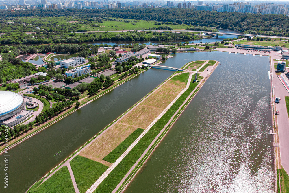 Rowing canal illuminated by bright sunshine. Panoramic view. Shooting from above, aerial filming. Olympic rowing canal in Moscow.