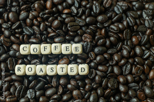 The coffee roasted and text wood cube close up image.