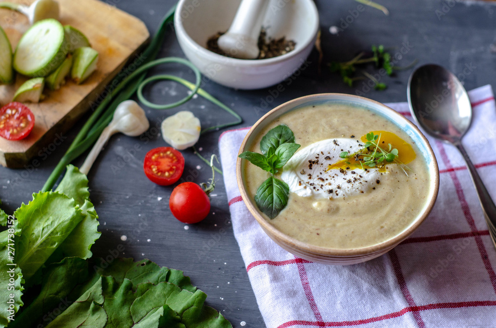 Healthy zucchini cream soup served with poached egg and greens. Proper nutrition food Healthy zucchini cream soup served with poached egg and greens. Proper nutrition food