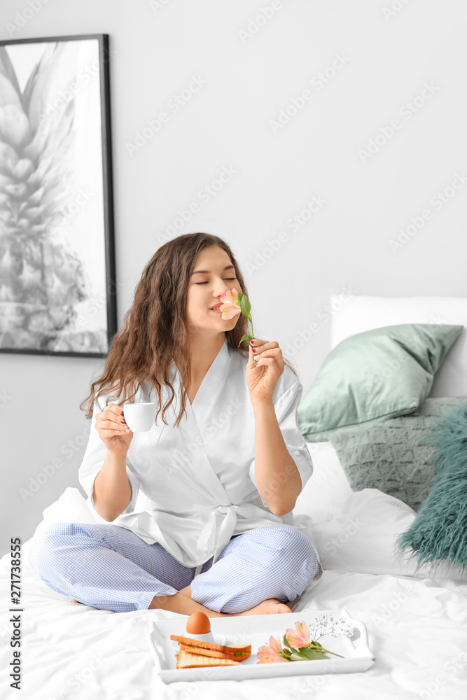 Beautiful young woman having breakfast in bed Beautiful young woman having breakfast in bed