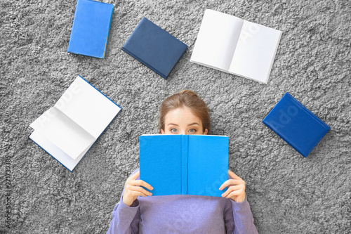 Young woman with books lyin...