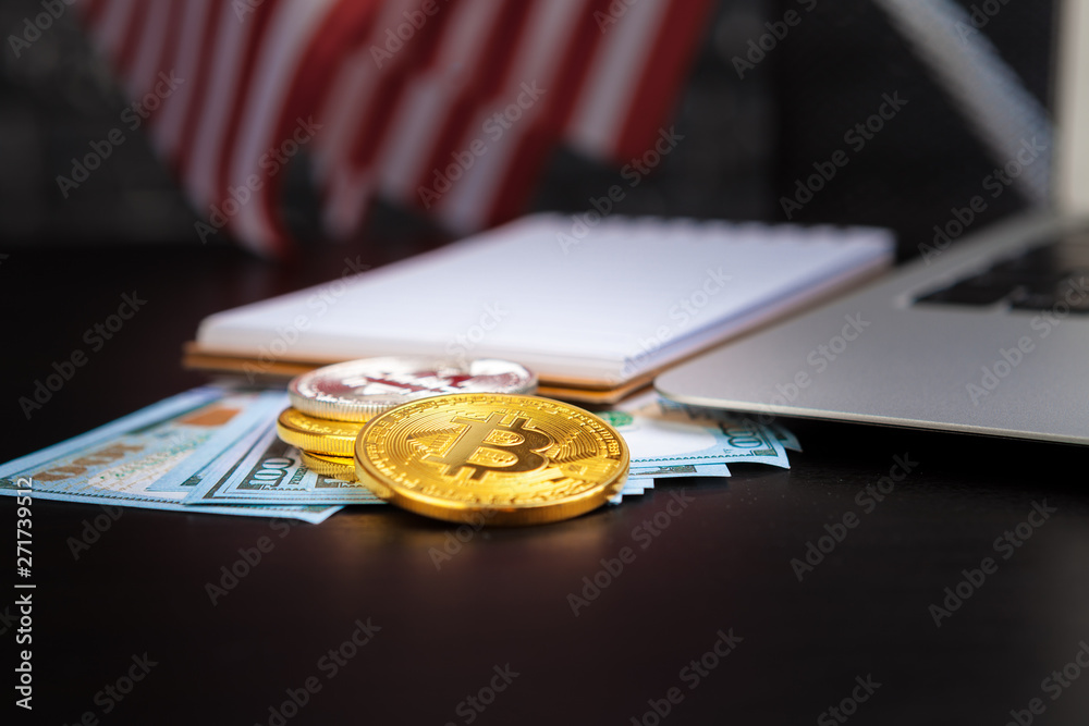 golden bitcoin coin on us dollars close up. Electronic crypto currency