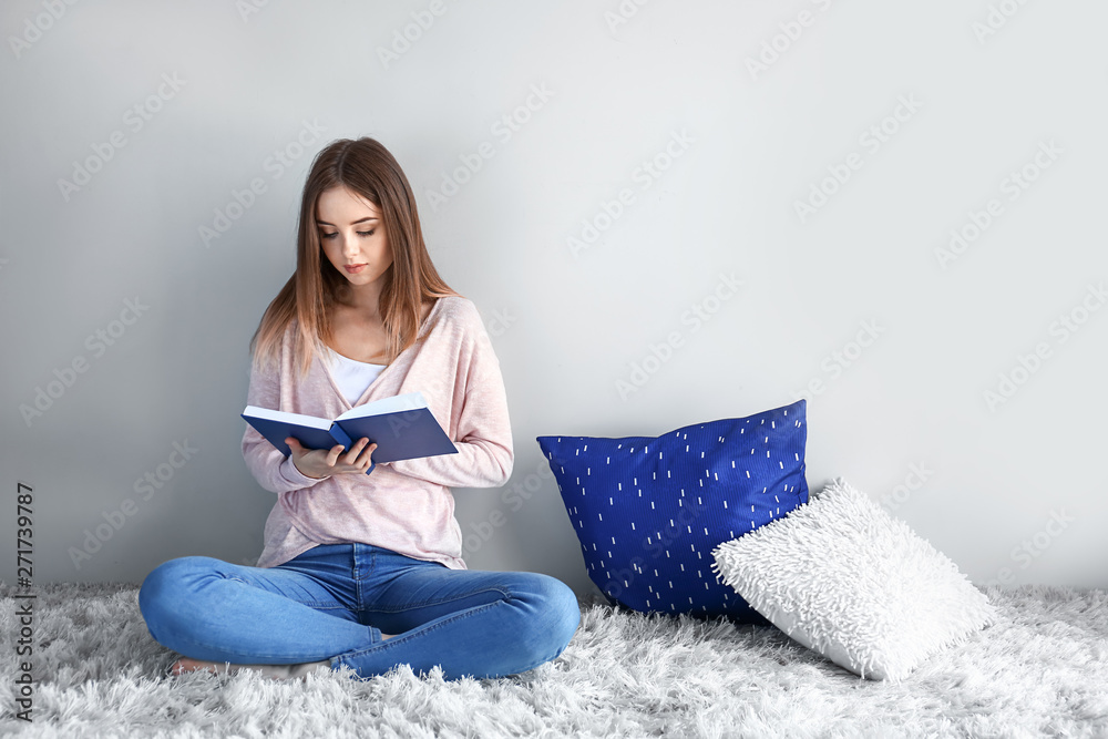 Beautiful young woman reading book at home Beautiful young woman reading book at home