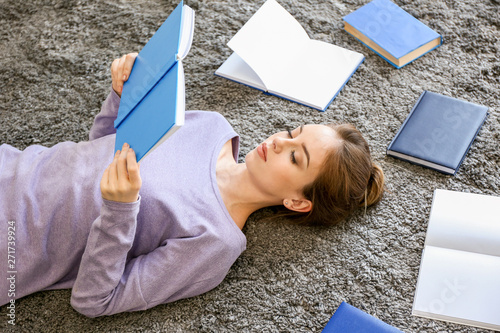 Female student reading book...