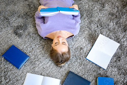 Female student reading book...
