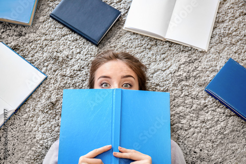 Female student reading book...