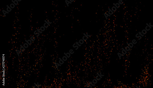 Burning red hot sparks rise from large fire in the night sky. Beautiful abstract background on the theme of fire, light and life. Fiery orange glowing flying away particles over black background