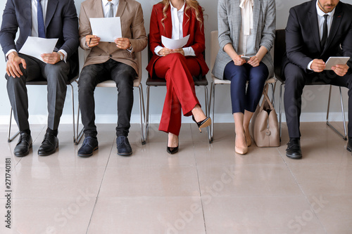 Young people waiting for job interview indoors photo