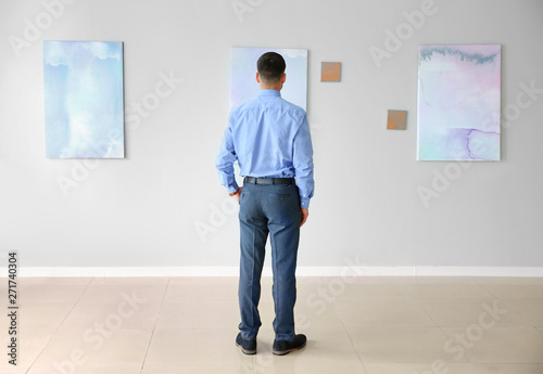 Man at exhibition in modern art gallery