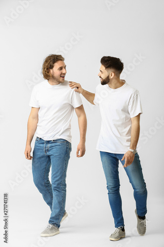 Stylish young men in jeans ...