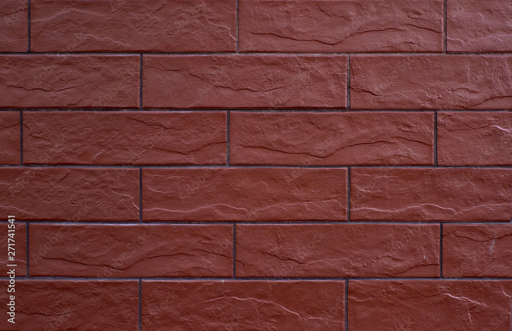 Obraz premium fragment of a wall of brown bricks bonded with cement