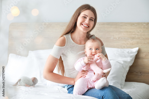 Happy mother with cute litt...