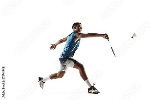 Little boy playing badminton isolated on white studio background. Young male model in sportwear and sneakers with the racket in action, motion in game. Concept of sport, movement, healthy lifestyle. © master1305