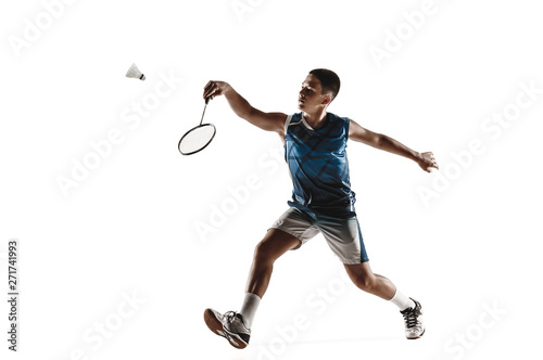 Little boy playing badminton isolated on white studio background. Young male model in sportwear and sneakers with the racket in action, motion in game. Concept of sport, movement, healthy lifestyle.