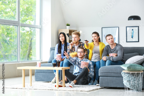 Friends watching TV at home