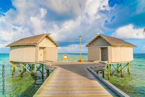 Fototapeta Naklejka Na Ścianę i Meble -  Beautiful water villas in tropical Maldives island at the sunrise time .