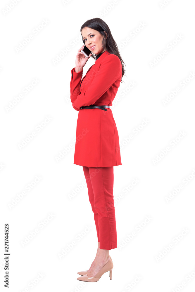 Successful confident happy business woman in suit having phone call smiling and looking at camera. Full body isolated on white background. Successful confident happy business woman in suit having phone call smiling and looking at camera. Full body isolated on white background.