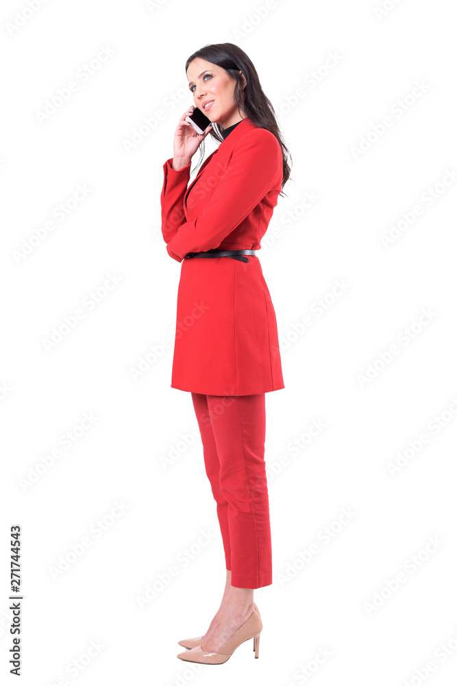Side view of happy relaxed attractive business woman standing and talking on the cellphone. Full body isolated on white background.