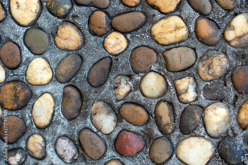 Brown stones on gray background. Texture.