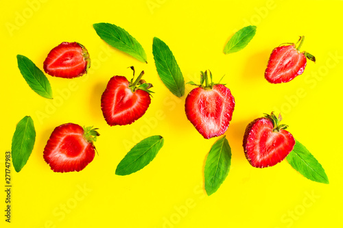 Fototapeta Naklejka Na Ścianę i Meble -   Strawberries and mint leaves on a bright yellow background. Background for the design of banners, websites, blogs. 