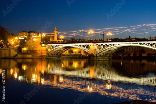bridge triana sevilla andalucia spain at night with lights photo