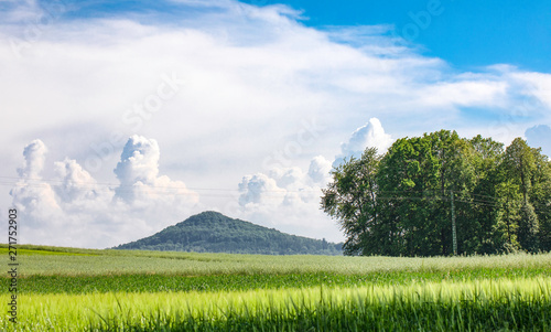 Extinct volcano in the Katzbach Mountains or Kaczawskie Mountains. Clouds formations on the blue sky. photo