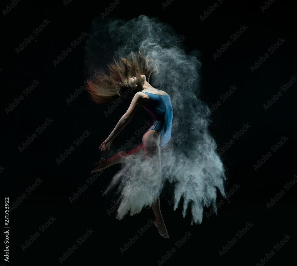 © Wisky - Female dancer jumping in cloud of dust